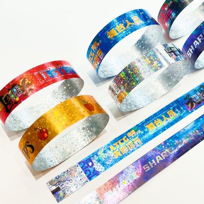 Venta caliente Brillante Laser Glitter Muñeca promocional impermeable de papel de láser Brazalete para niños y adultos Eventos de admisión Muñeca